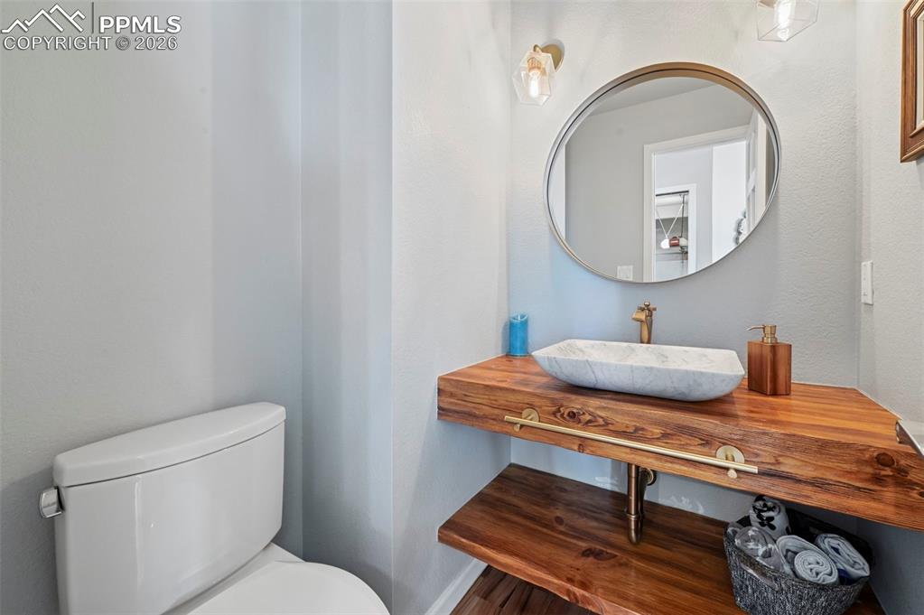 Half bathroom featuring vanity and toilet
