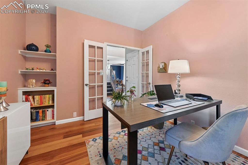 Office area with french doors and wood finished floors