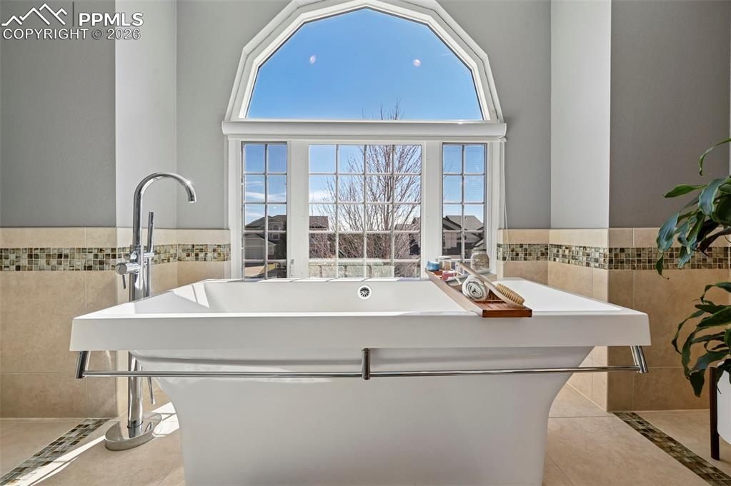 Kitchen featuring tile walls and a wainscoted wall