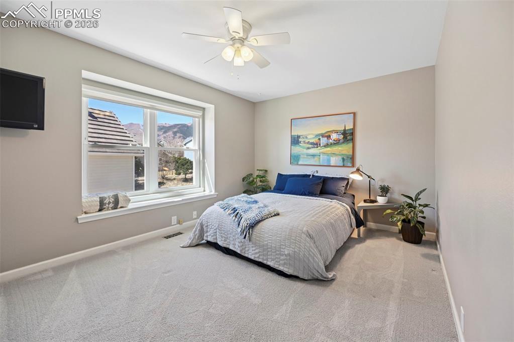 Bedroom featuring ceiling fan and light colored carpet