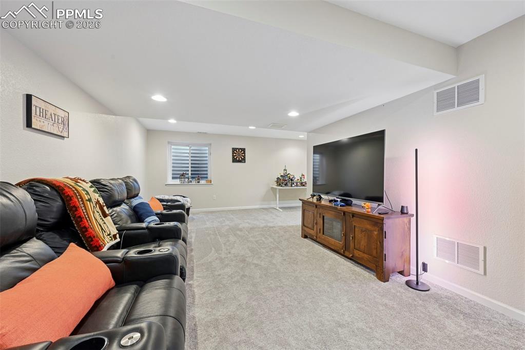 Living room with light colored carpet and recessed lighting