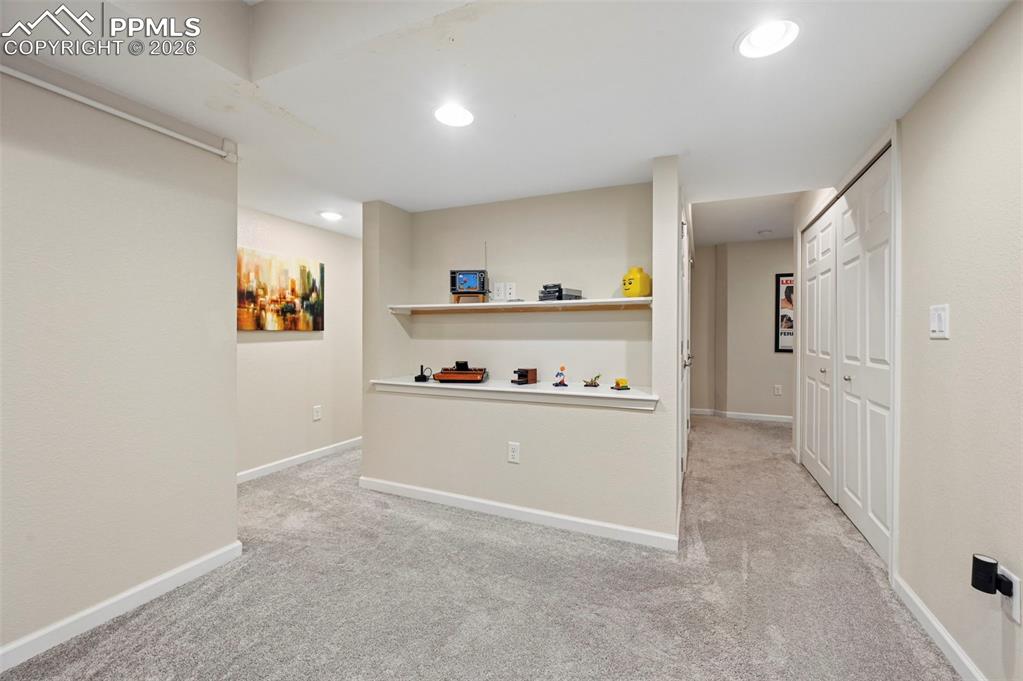 Bar area featuring light colored carpet and recessed lighting