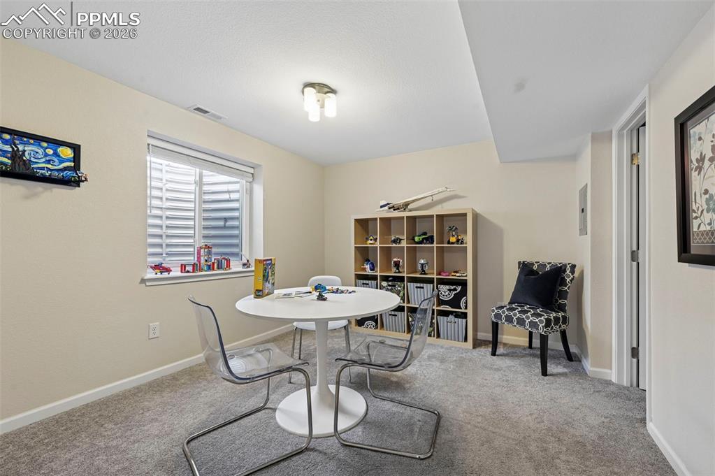 Dining room featuring carpet flooring and baseboards