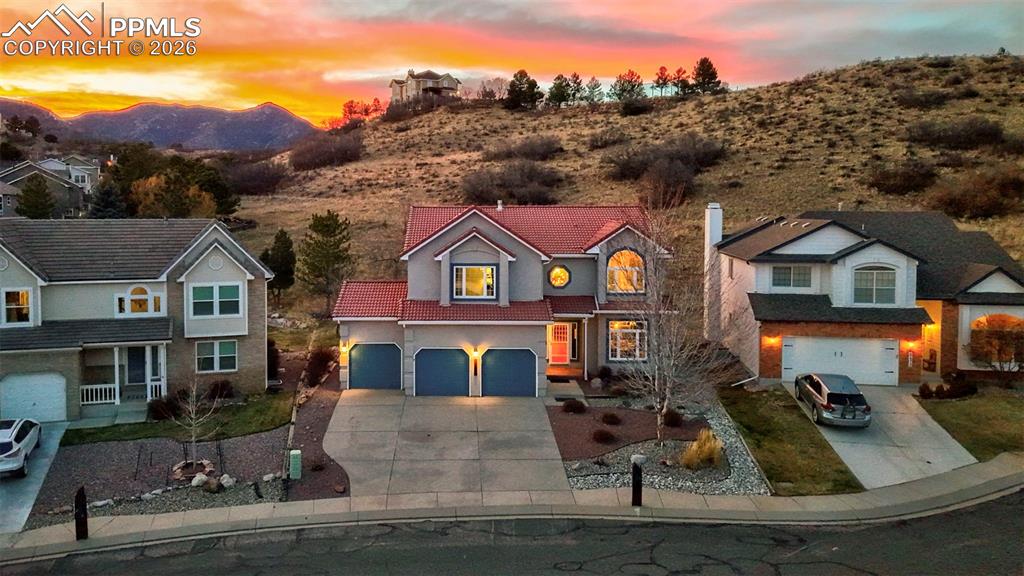Traditional home with concrete driveway and an attached garage