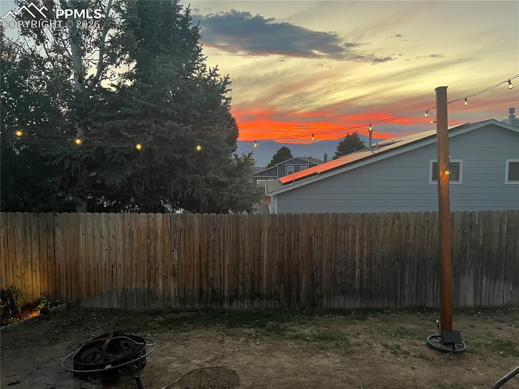 Yard at dusk with an outdoor fire pit