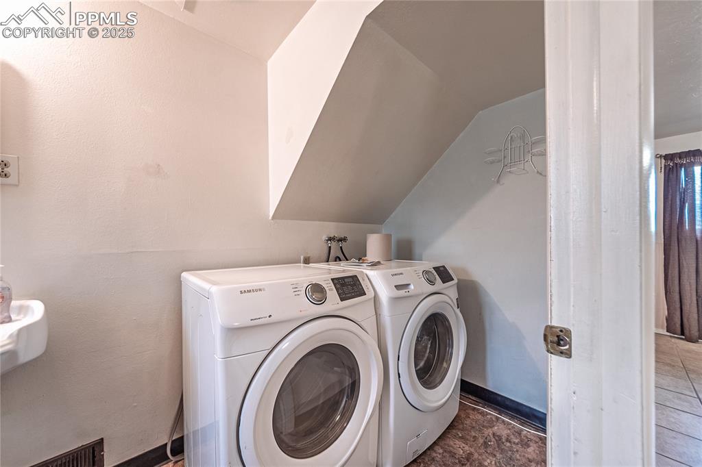 Laundry area with washer and clothes dryer