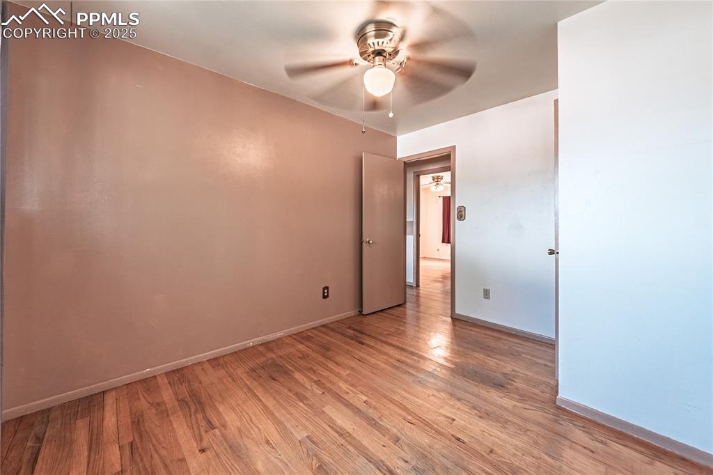 Spare room with light wood finished floors and a ceiling fan
