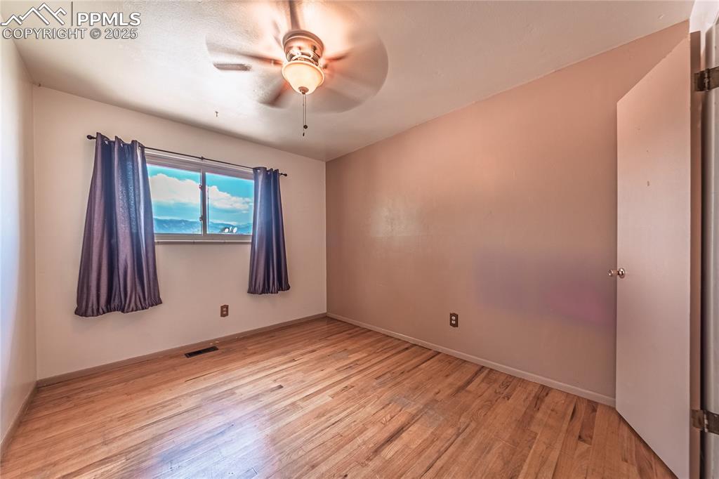 Spare room featuring light wood-style floors and a ceiling fan