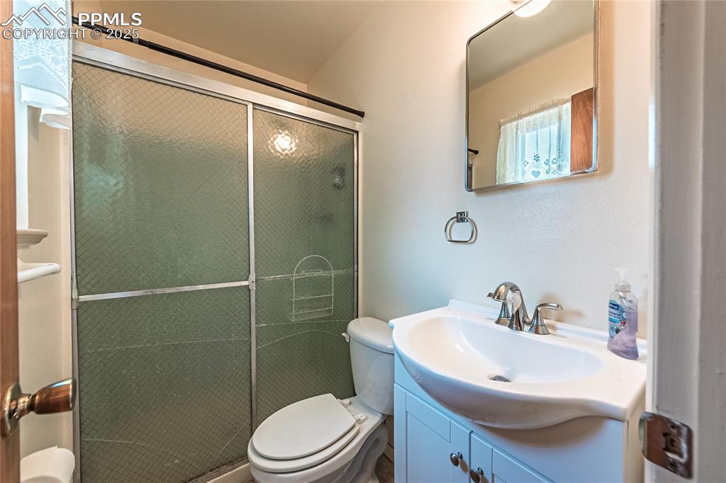Bathroom featuring vanity and a shower stall