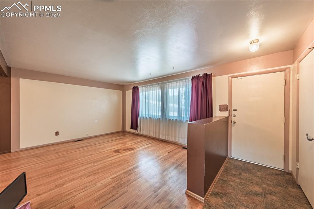 Entrance foyer with wood finished floors and baseboards