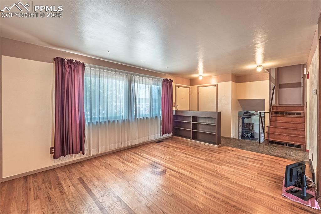 living room with light wood finished floors and stairway