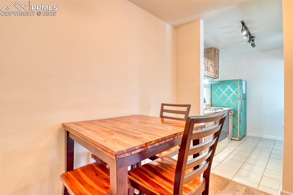 Dining space featuring track lighting and light wood finished floors