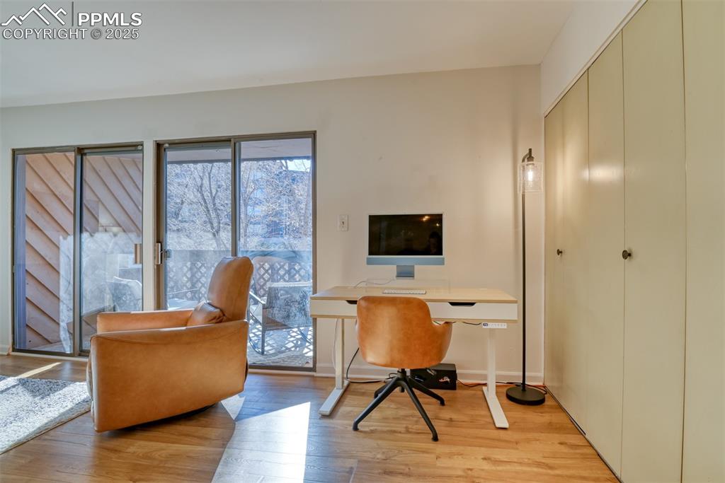 Home office with light wood-style flooring