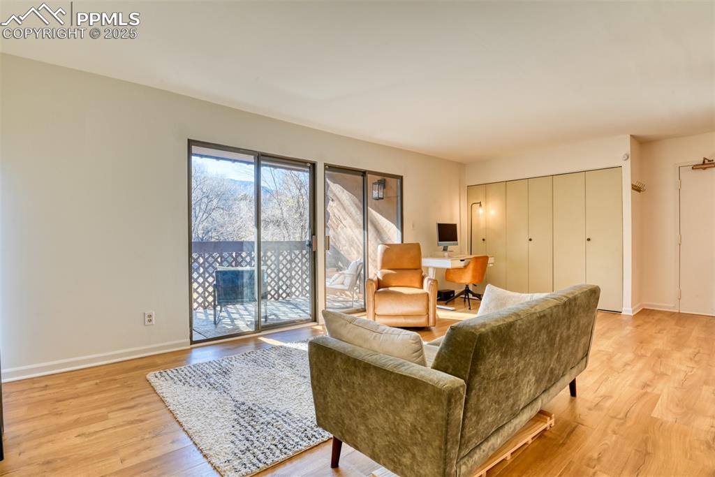Living room with an office area and light wood finished floors
