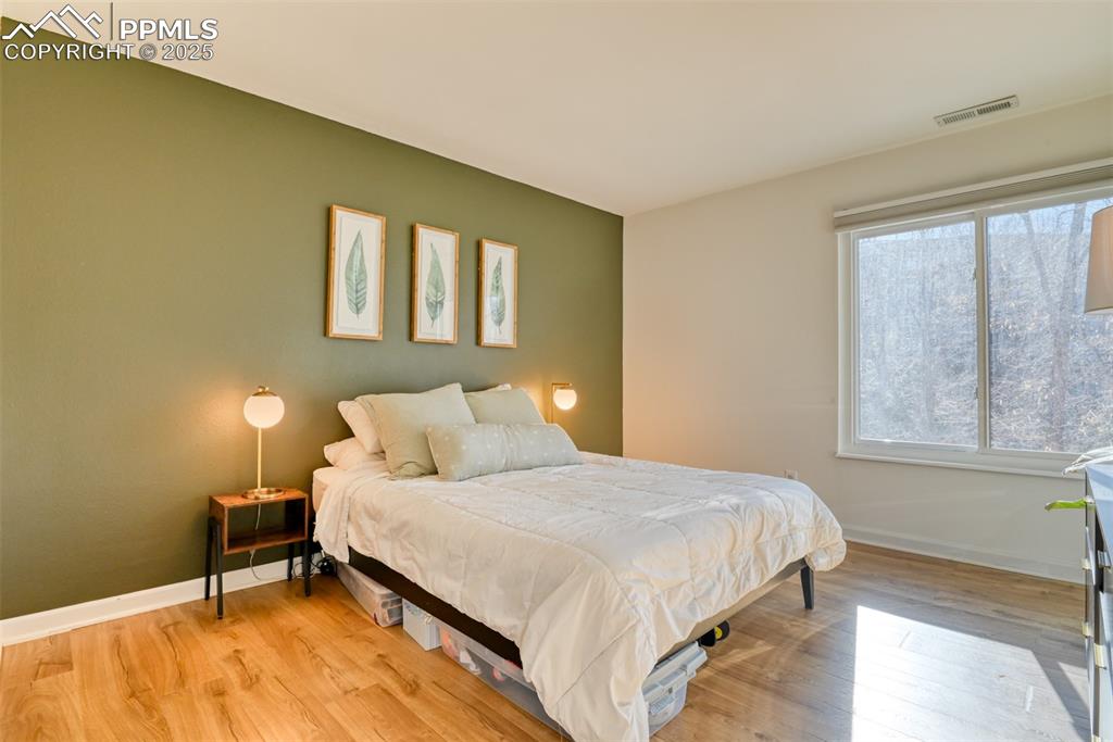 Bedroom with light wood finished floors and baseboards