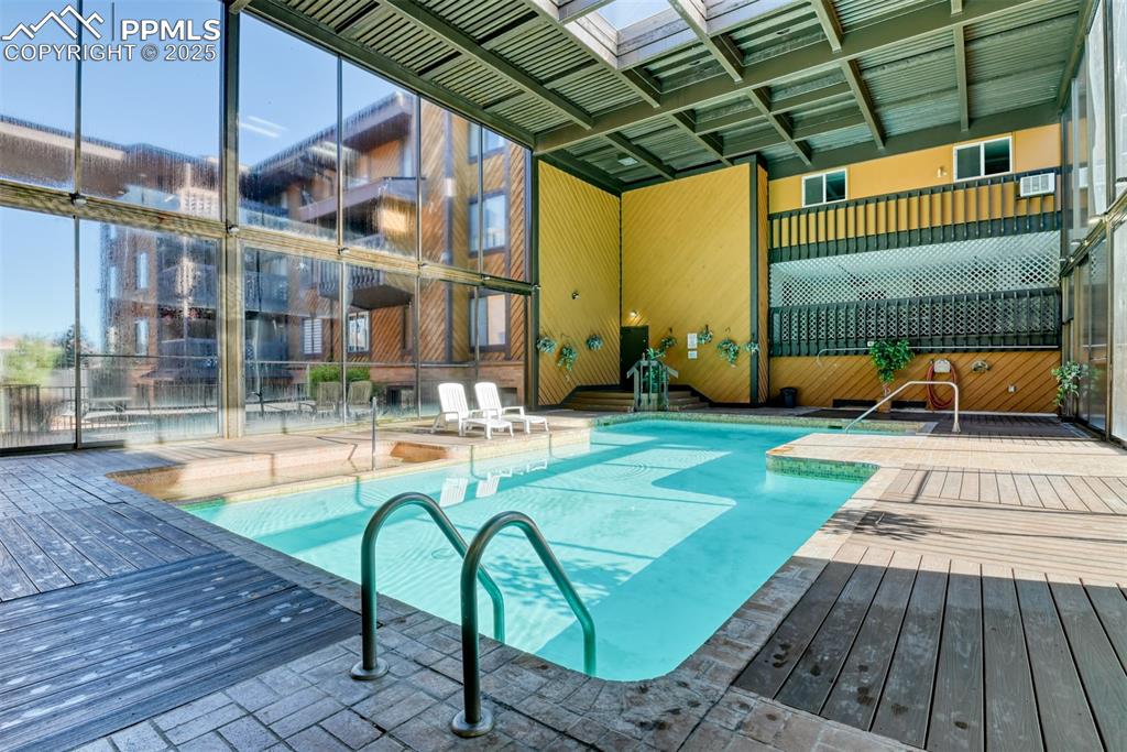 Indoor pool featuring a wooden deck