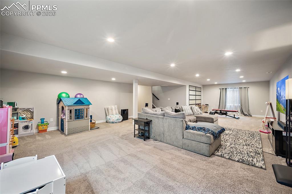 Living room with light carpet and recessed lighting