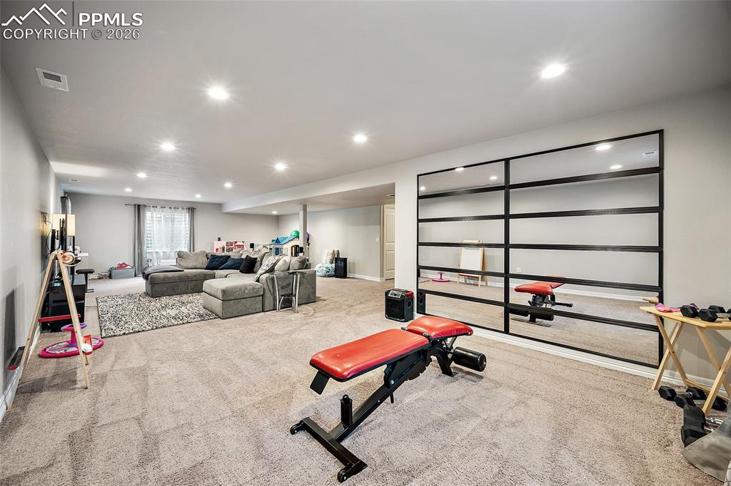 Exercise room with carpet and recessed lighting