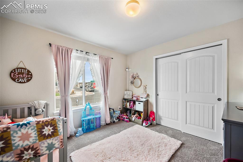 Bedroom with carpet and a closet