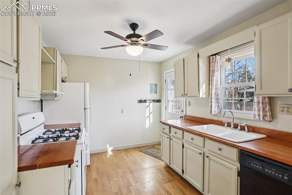 Kitchen with gas burning stove, matching appliances and a walk out to the back deck/yard