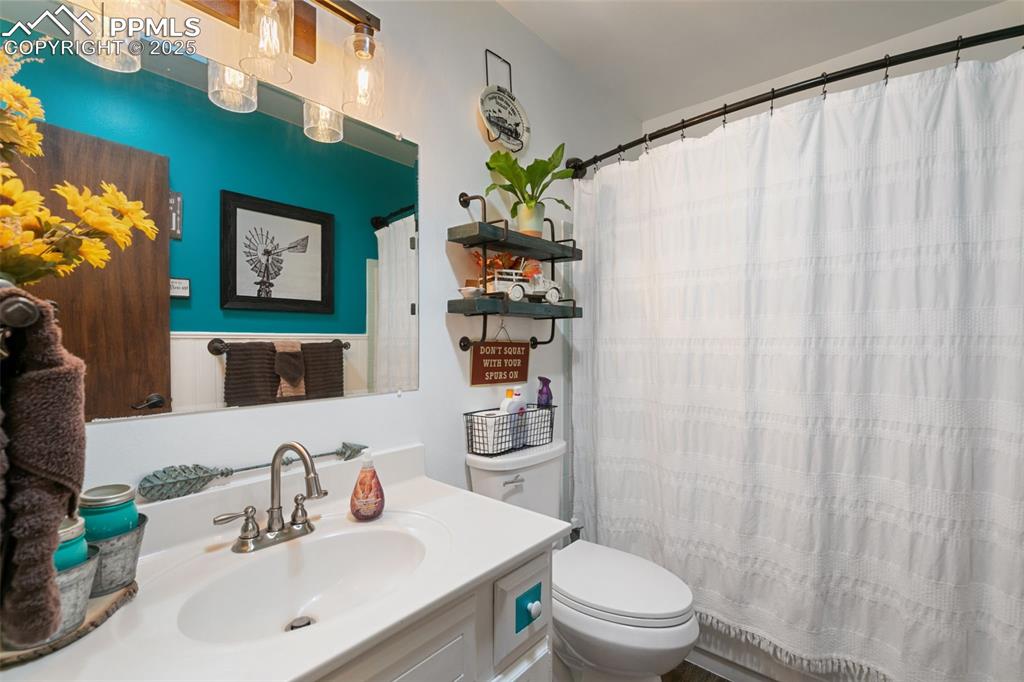 Full bathroom featuring vanity and a shower with shower curtain