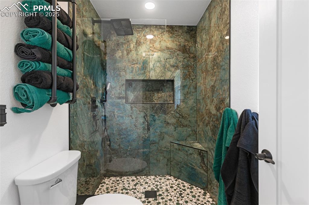 Bathroom featuring a marble finish shower