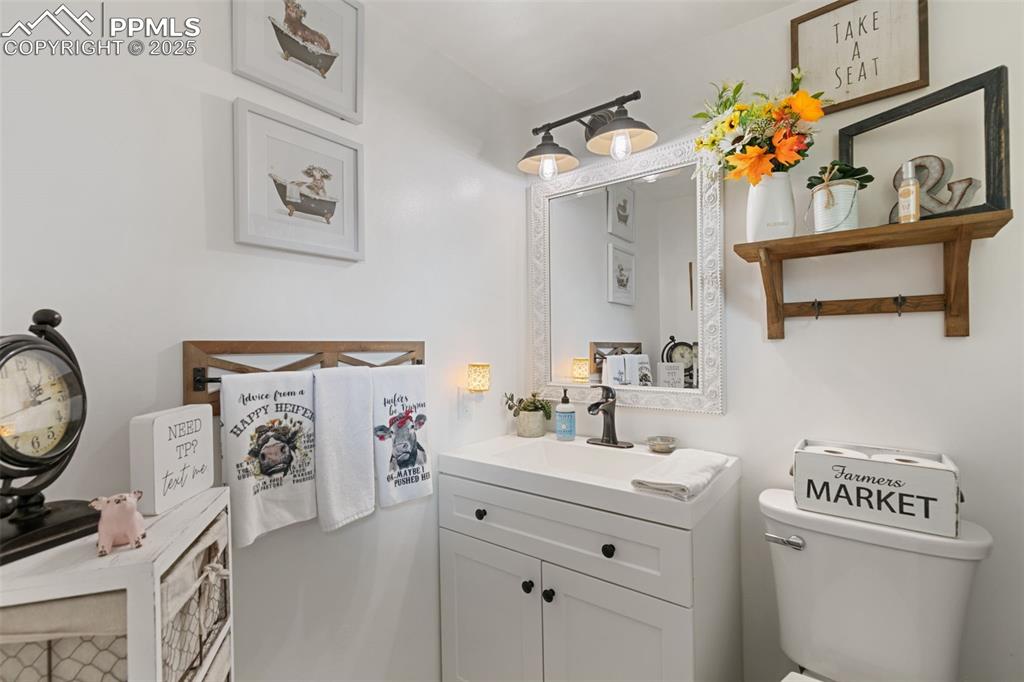 Half bathroom with vanity and toilet