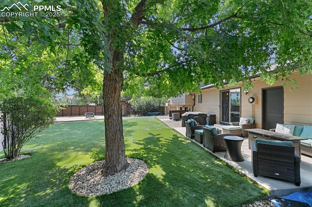 Fenced backyard with a patio area and an outdoor hangout area