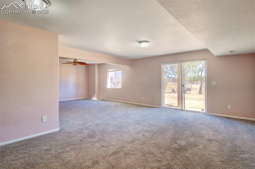 Recreation room in basement with walk out to covered patio