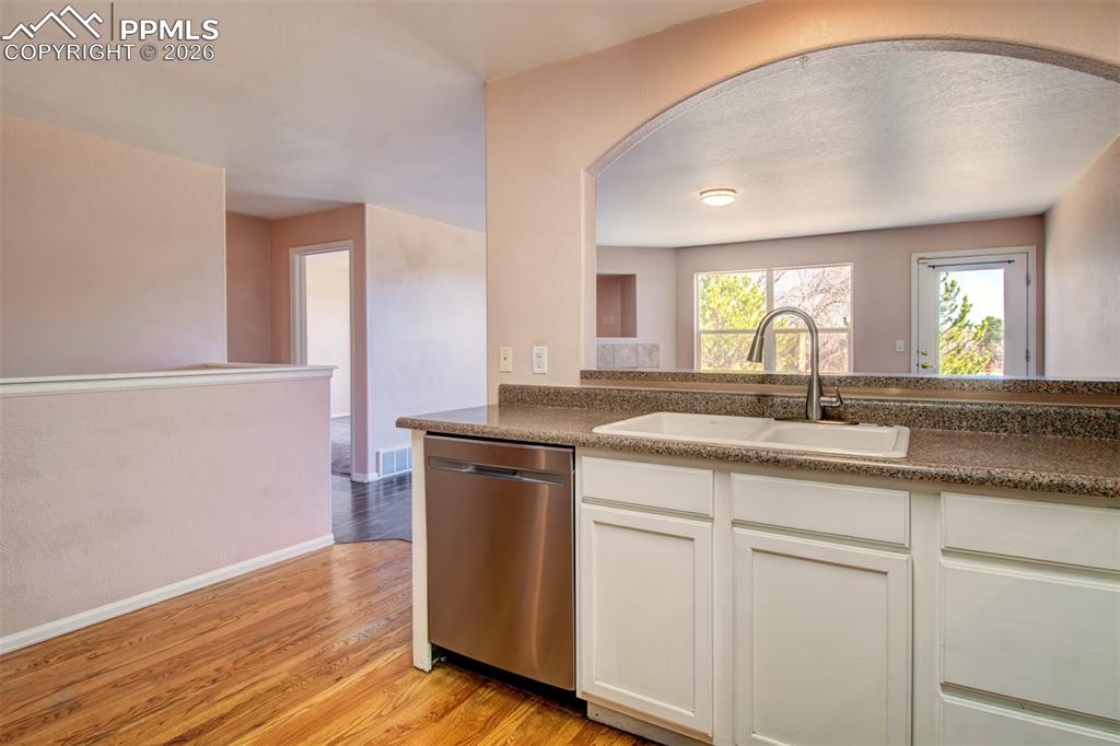 Kitchen with wood floors, stainless steel appliances and ample cabinet space