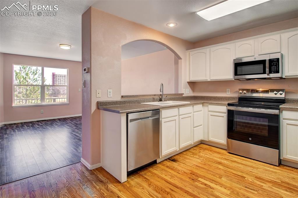 Kitchen with wood floors, stainless steel appliances and ample cabinet space