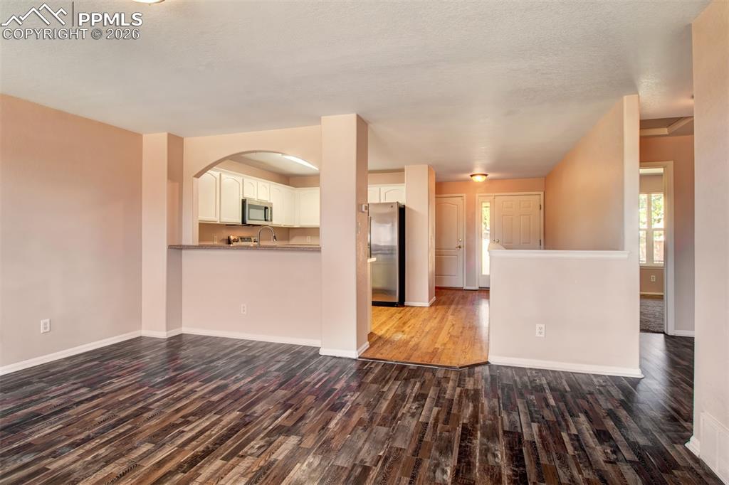 Living room with LVP flooring, a gas fireplace and a walk out to deck