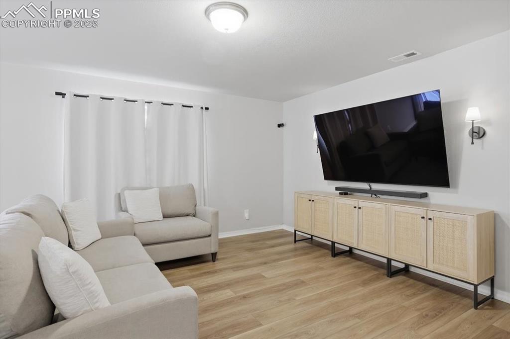 Living room featuring light wood finished floors and baseboards