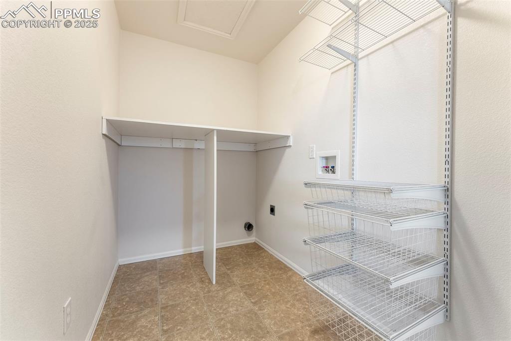 Laundry room with hookup for a washing machine and baseboards