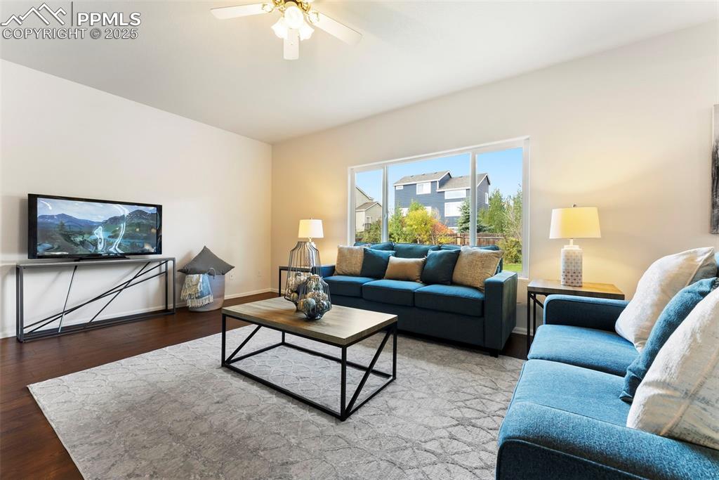 Living room featuring wood finished floors and ceiling fan