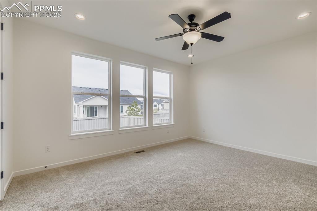 Empty room with light colored carpet, recessed lighting, and ceiling fan