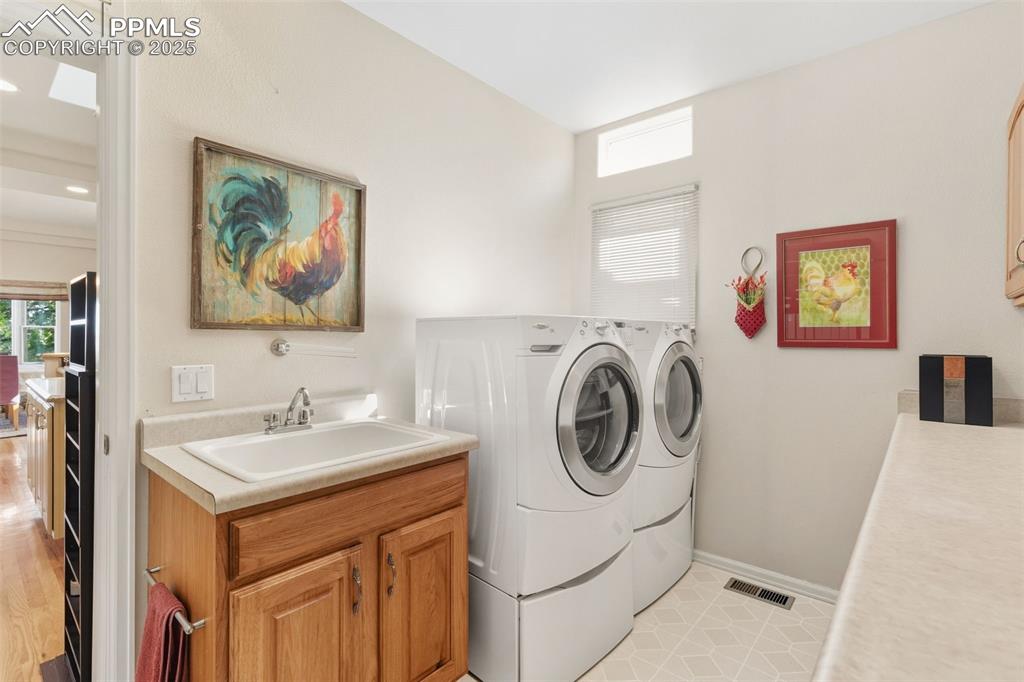 Big laundry room with sink and window.  Door to garage