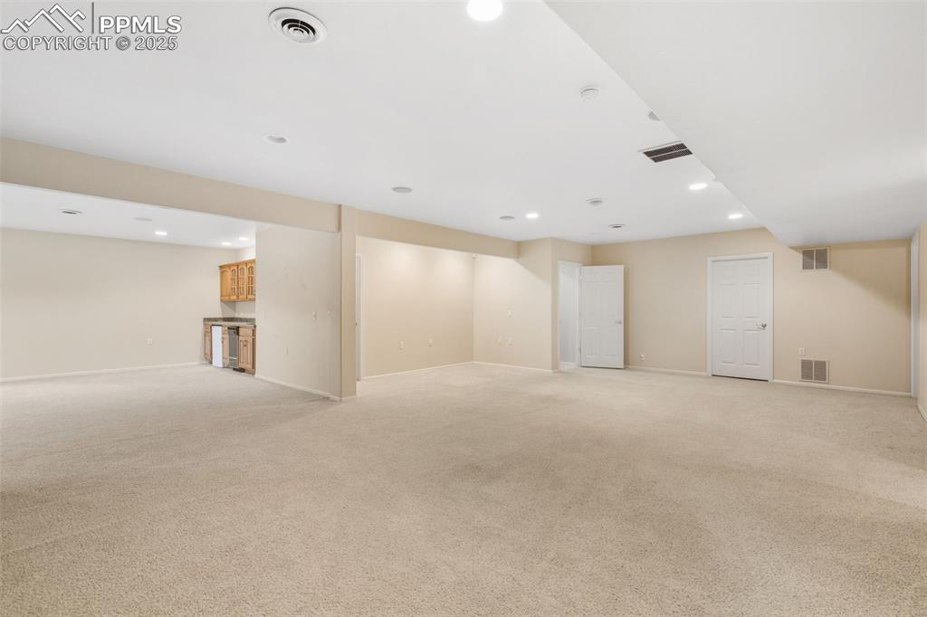 lOOKING FROM 1 FAMILY ROOM INTO THE 2ND FAMILY ROOM DOWNSTAIRS