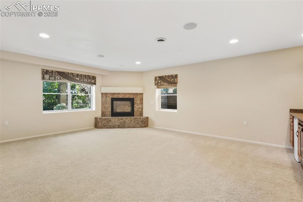 Family Room 2 of 2 downstairs.  Fireplace and Wet bar kitchenette