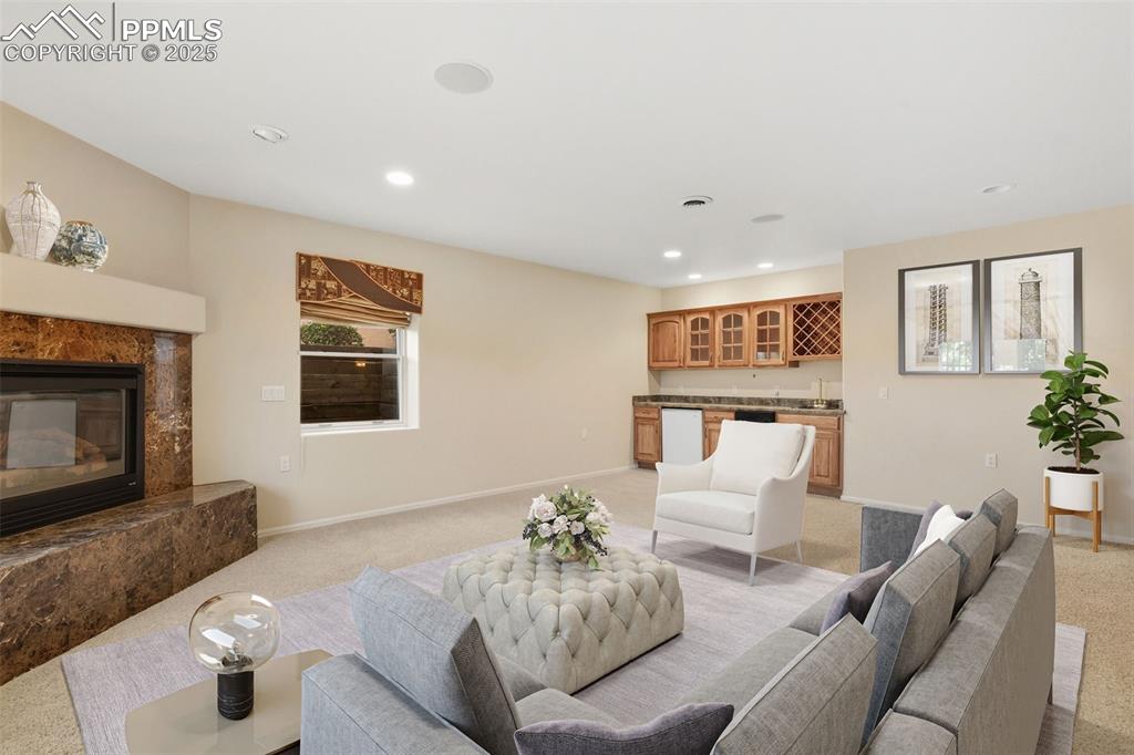 VIRTUAL STAGED FAMILY ROOM 2 of 2 with fireplace and kitchenette