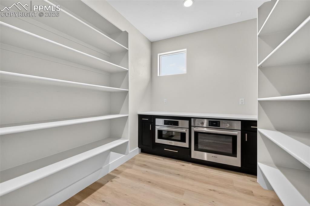 Large walk-in pantry with prep area and oven.