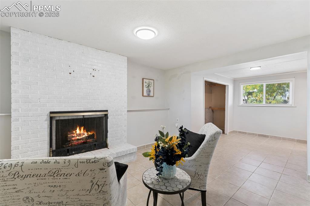 Tiled living area with a fireplace