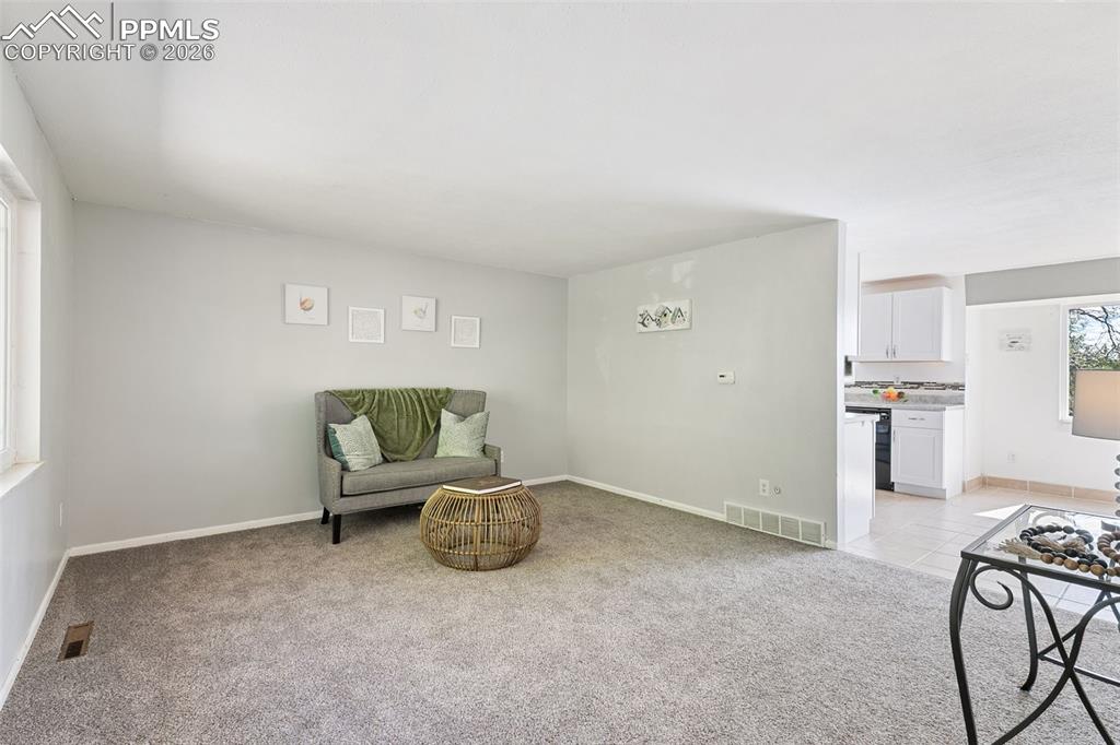 Sitting room featuring light colored carpet and baseboards