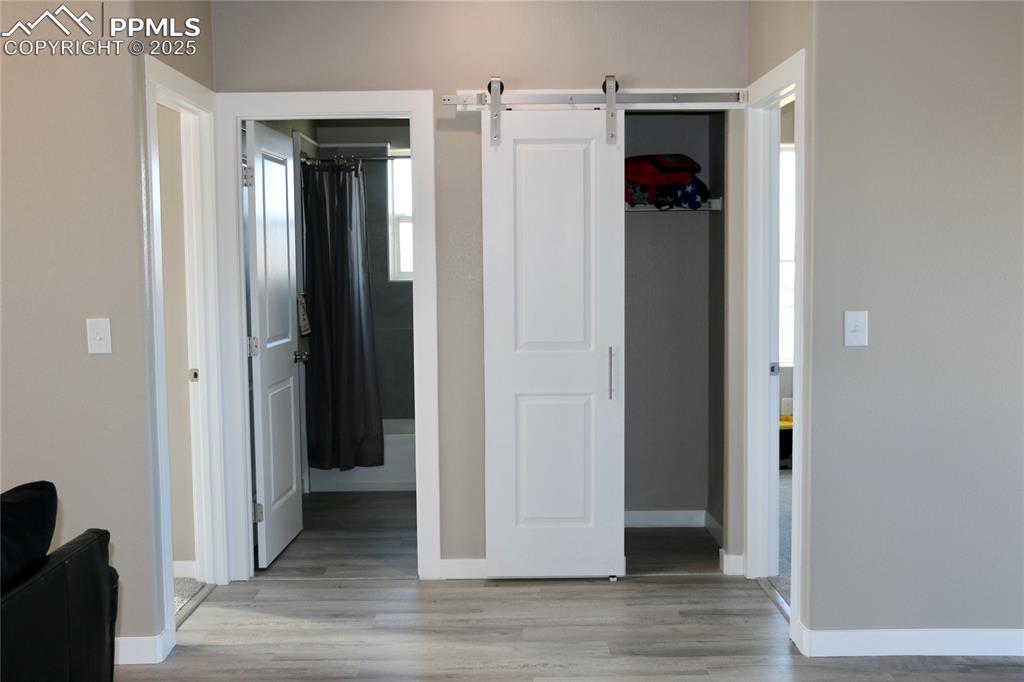 View of closet and bathroom located off the living area between two bedrooms.
