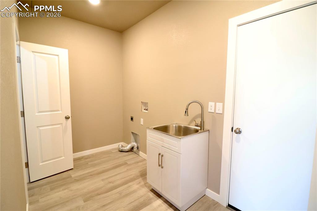 Laundry room off garage with attached half bath