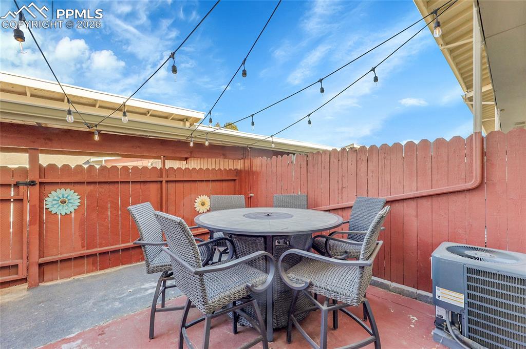 Fully fenced private patio-gate leads to covered parking.