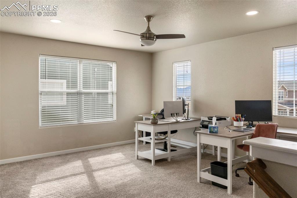 Office area featuring light colored carpet, a textured ceiling, ceiling fan, and recessed lighting