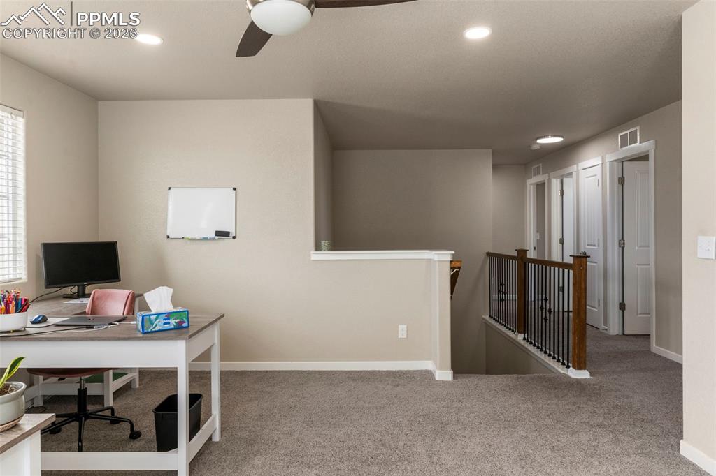 Office featuring light colored carpet, a ceiling fan, and recessed lighting