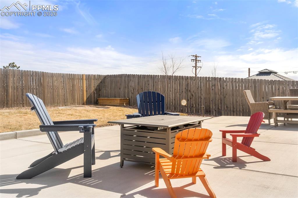 Fenced backyard featuring a patio area and outdoor dining area