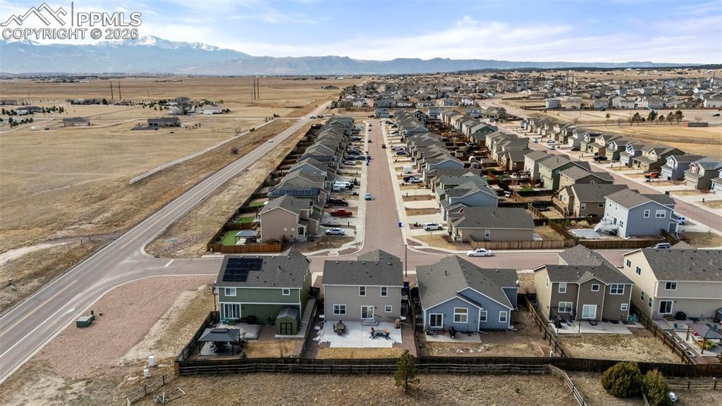 Aerial view of residential area featuring a mountainous background